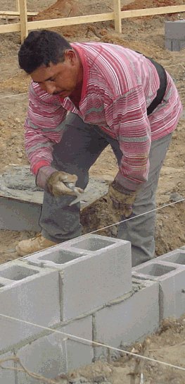 Concrete block foundation walls being laid on our first house.
