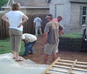 Susan watching over the landscape company's sod laying.