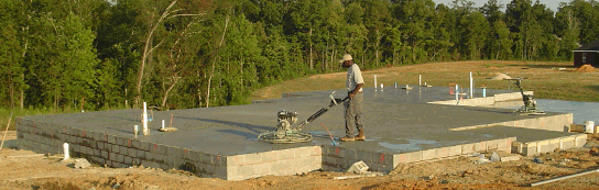 Power trowelling the surface of a freshly poured concrete slab.